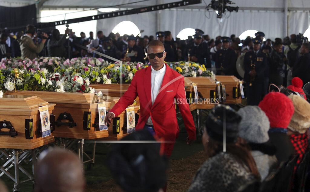 Uncredited People gather during a funeral service held in Scenery Park, East London, South Africa, Wednesday, July 6, 2022. More than a thousand grieving family and community members are attending the funeral in South Africa's East London for 21 teenagers who died in a mysterious tragedy at a nightclub nearly two weeks ago. South African President Cyril Ramaphosa is due to give the eulogy for the young who died. (AP Photo)