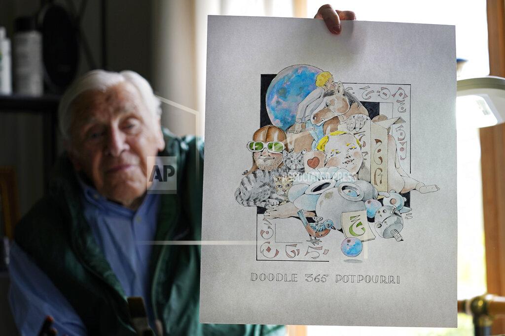Charles Krupa Artist Robert Seaman holds up the 365th daily doodle sketch in his room at an assisted living facility Monday, May 10, 2021, in Westmoreland, N.H. Seaman, who moved into the facility weeks before the COVID-19 pandemic shutdown his outside world in 2020, recently completed his 365th daily sketch, or what he calls his "Covid Doodles", since being isolated due to the virus outbreak. (AP Photo/Charles Krupa)