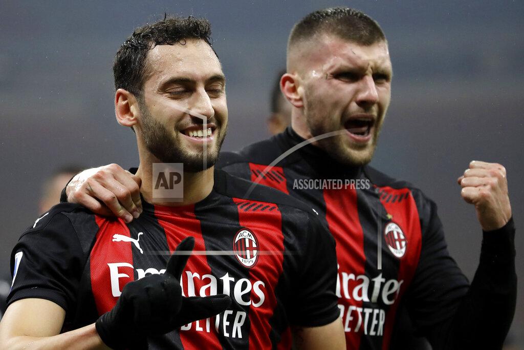 Luca Bruno AC Milan's Hakan Calhanoglu, left, celebrates with his teammate AC Milan's Ante Rebic, his goal against Lazio during a Serie A soccer match between AC Milan and Lazio, at the San Siro stadium in Milan, Italy, Wednesday, Dec. 23, 2020. (AP Photo/Luca Bruno)