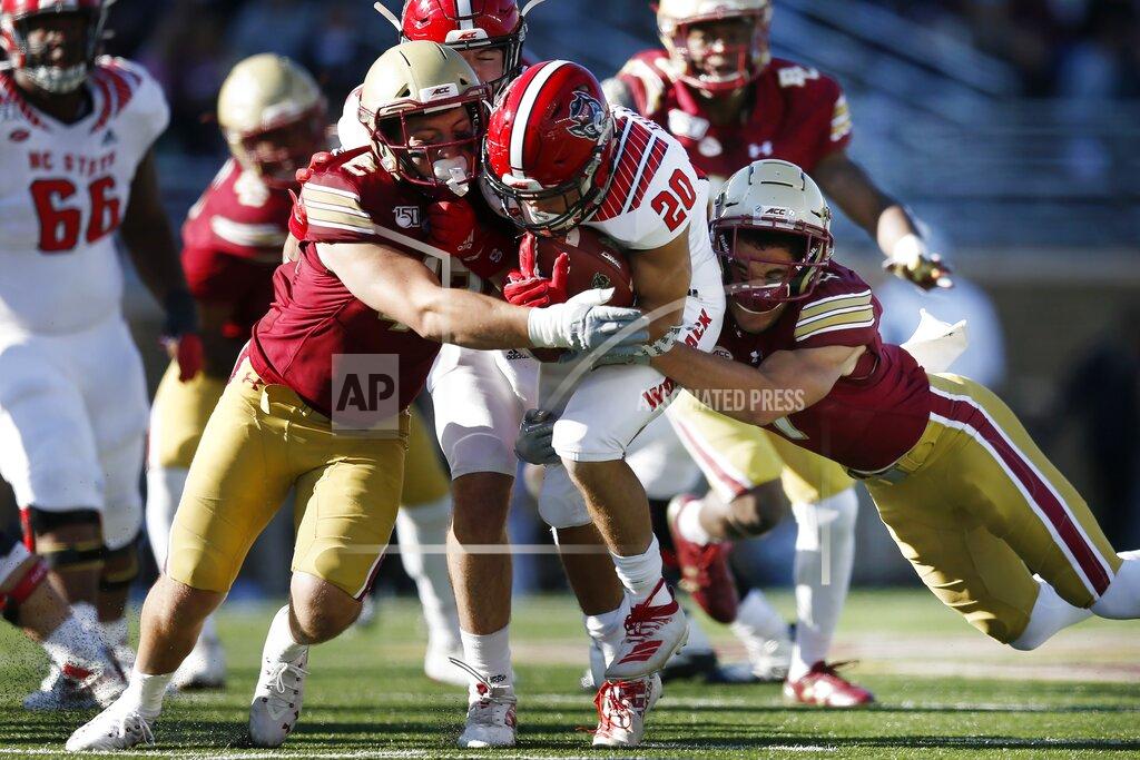 Michael Dwyer Boston College defensive back Tate Haynes, right, and linebacker Vinny DePalma, left, tackle North Carolina State running back Jordan Houston (20) during the second half of an NCAA college football game in Boston, Saturday, Oct. 19, 2019. (AP Photo/Michael Dwyer)