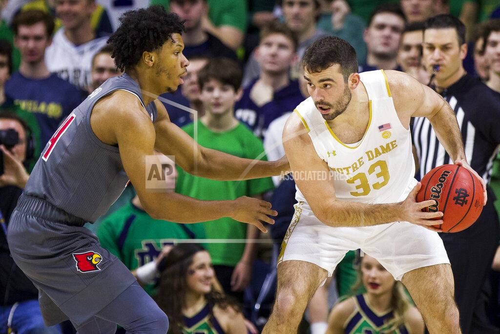 Robert Franklin Notre Dame's John Mooney (33) gets pressure from Louisville's Dwayne Sutton (24) during the first half of an NCAA college basketball game Saturday, Jan. 11, 2020, in South Bend, Ind. (AP Photo/Robert Franklin)