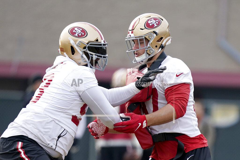 Tony Avelar San Francisco 49ers defensive tackle Earl Mitchell, left, and defensive end Nick Bosa, right, go through drills during NFL football practice at the team's training facility in Santa Clara, Calif., Wednesday, Jan. 15, 2020. The 49ers will host the Green Bay Packers for the NFC Championship on Sunday. (AP Photo/Tony Avelar)