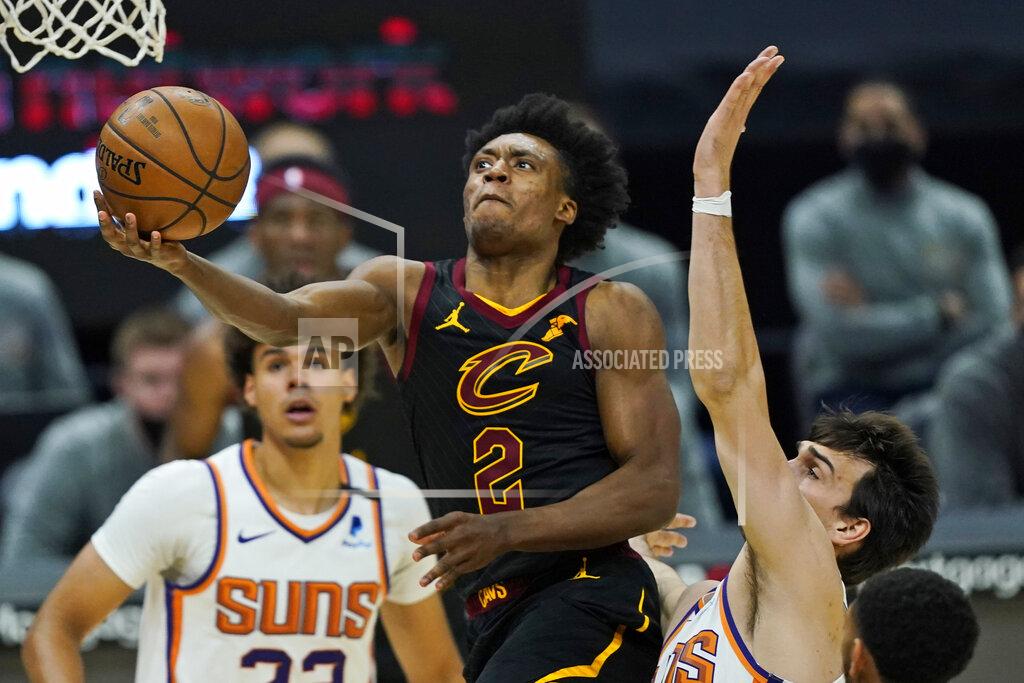 Tony Dejak Cleveland Cavaliers' Collin Sexton, left, drives to the basket against Phoenix Suns' Dario Saric in the second half of an NBA basketball game, Tuesday, May 4, 2021, in Cleveland. (AP Photo/Tony Dejak)