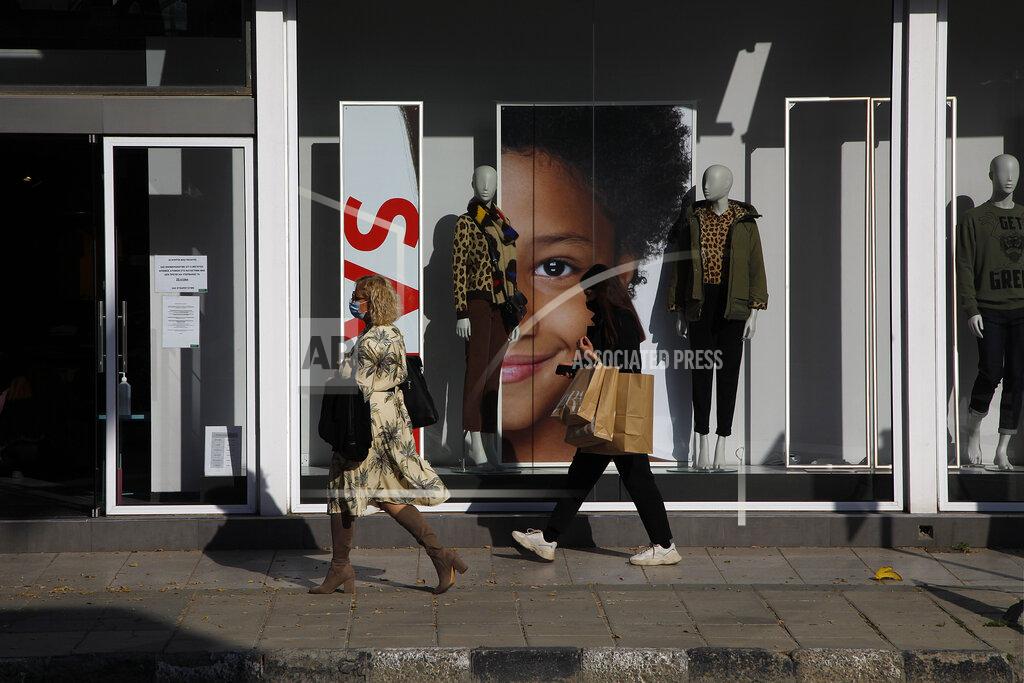 Petros Karadjias Women wearing face masks walk at Archbishop Makarios shopping street in central Nicosia, Friday, Jan. 8, 2021. Cyprus is returning to lockdown mode for the remainder of the month with daytime restrictions on movement and a shuttering of schools after the country's health minister conceded that a raft of tough measures already in place including a night-time curfew weren't enough to curtail the spread of the coronavirus. (AP Photo/Petros Karadjias)