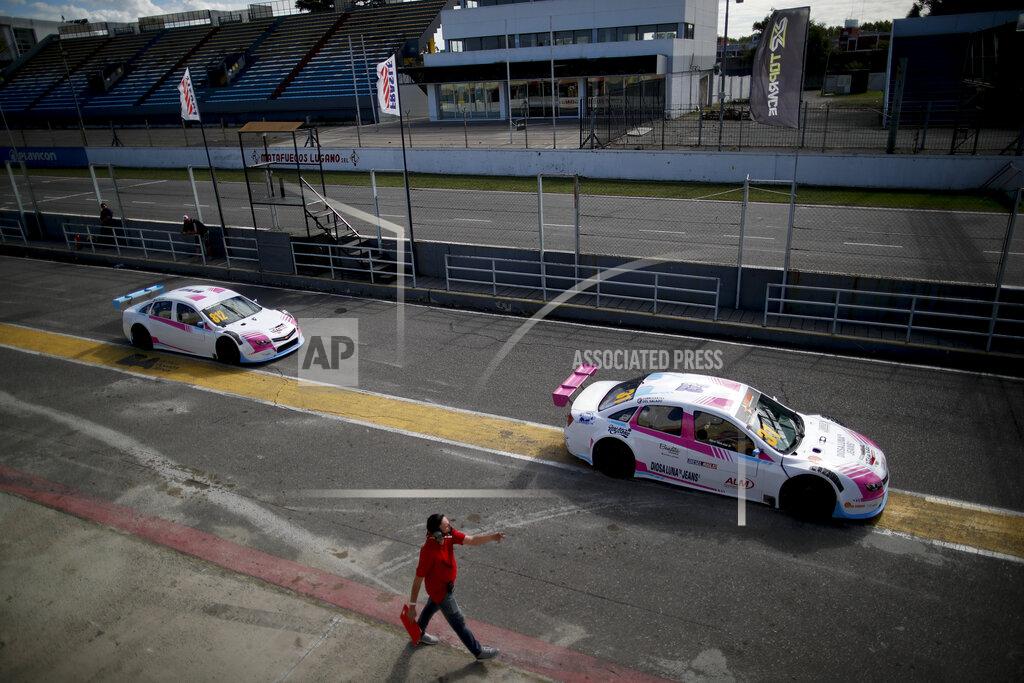 Natacha Pisarenko Vitarti Girl's Team drivers Karina Dobal, right, and Rocio Migliore leave the pits in their race cars for a practice session at the Oscar y Juan Galvez track in Buenos Aires, Argentina, Friday, April 2, 2021. They are the first all-female team in Argentina's motorsport history. (AP Photo/Natacha Pisarenko)