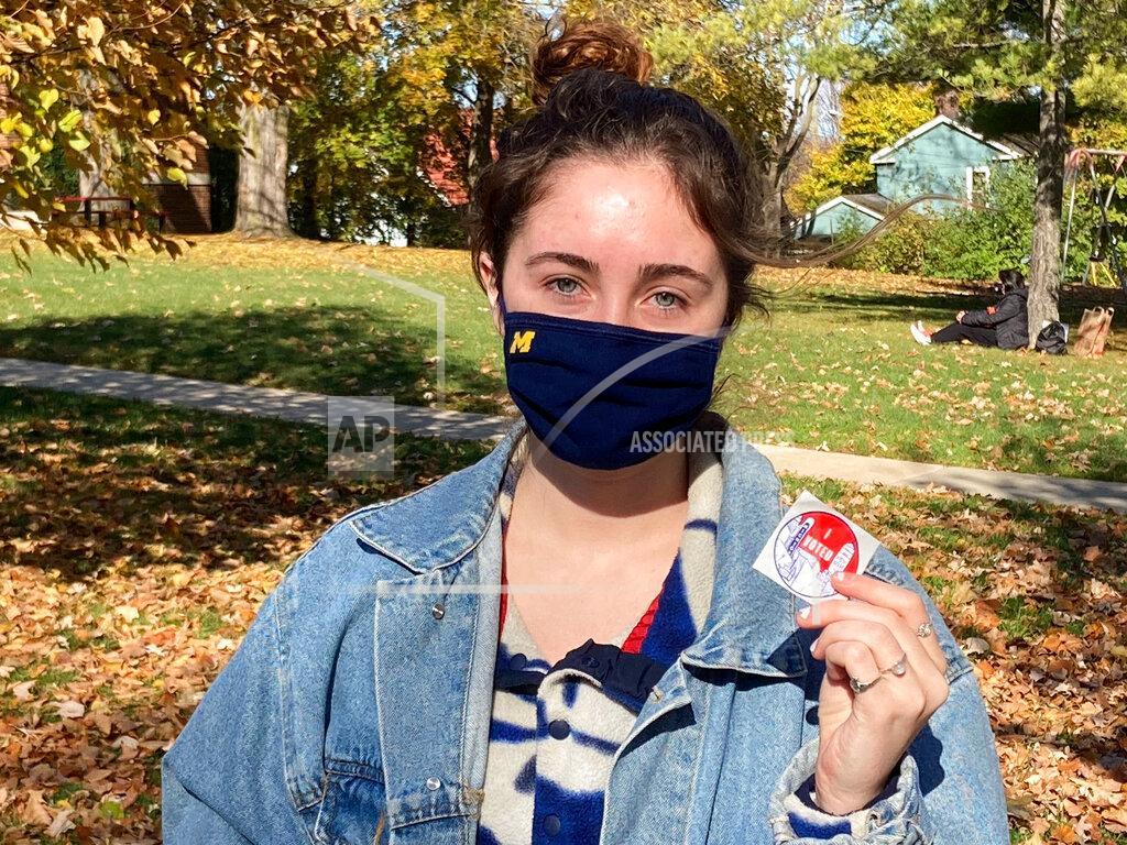 Noah Trister Georgia Richardson-Smaller shows off her I Voted sticker Tuesday, Nov. 3, 2020 in Ann Arbor, Mich. Smaller, an undergraduate who wore a mask with Michigan's block 'M' on it, said she voted for Biden. She cited health care, equality and police brutality as the most important issues facing the country. (AP Photo/Noah Trister)