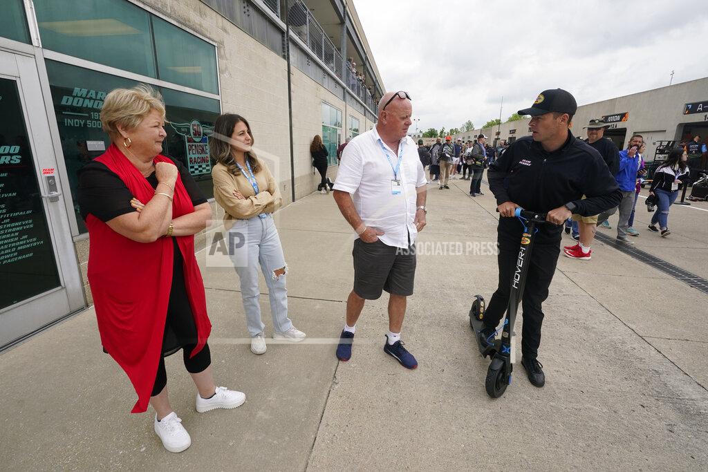 Darron Cummings Scott McLaughlin, right, of New Zealand, talks with his parents Wayne and Diane McLaughlin, and his wife Karly McLaughlin, second from left, in Gasoline Alley before qualifications for the Indianapolis 500 auto race at Indianapolis Motor Speedway, Sunday, May 22, 2022, in Indianapolis. (AP Photo/Darron Cummings)