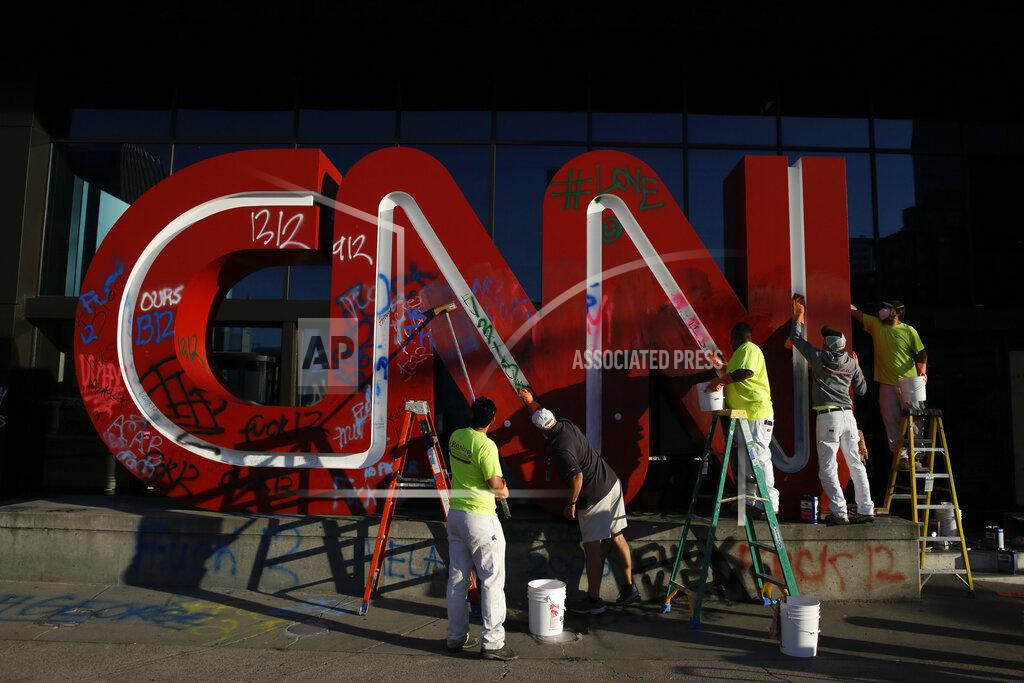 Brynn Anderson EDS NOTE: GRAPHIC CONTENT - The CNN sign is cleaned at the CNN Center, in the aftermath of a demonstration against police violence on Saturday, May 30, 2020, in Atlanta. (AP Photo/Brynn Anderson)