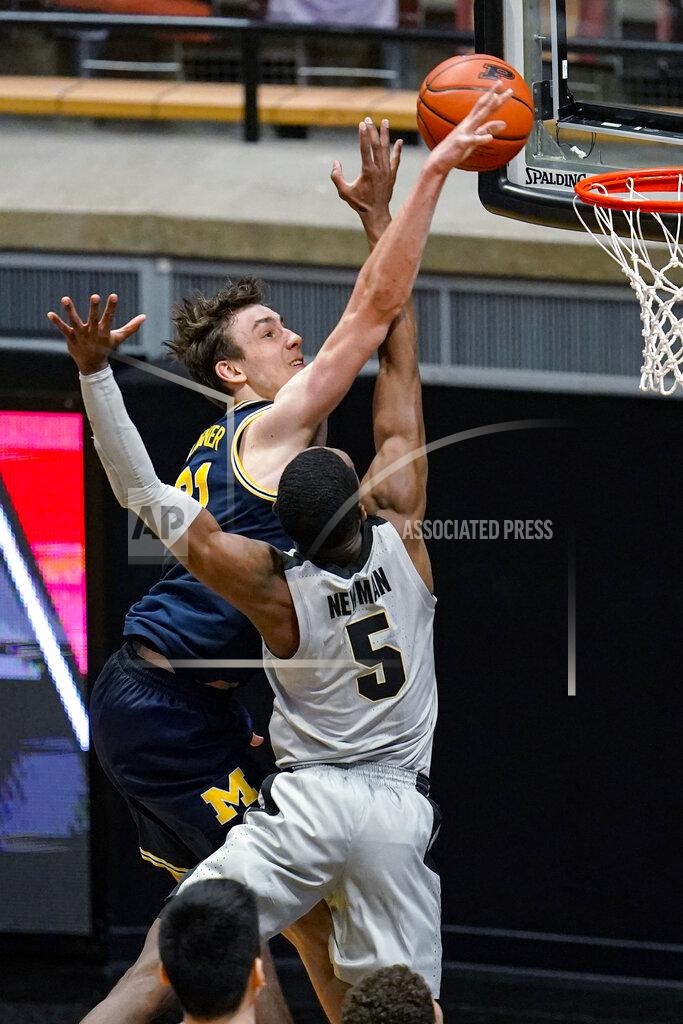 Michael Conroy Purdue guard Brandon Newman (5) blocks the shot of Michigan guard Franz Wagner (21) during the second half of an NCAA college basketball game in West Lafayette, Ind., Friday, Jan. 22, 2021. (AP Photo/Michael Conroy)