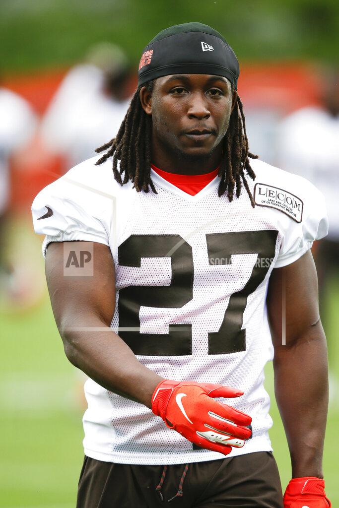 FILE - In this May 22, 2019 file photo Cleveland Browns' Kareem Hunt walks off the field during an NFL football organized team activity session at the team's training facility in Berea, Ohio. The Browns say they've spoken to suspended running back Kareem Hunt about an incident this weekend outside a downtown bar, Monday, July 1, 2019. The 23-year-old Hunt got into an argument with a friend late Saturday night. A video obtained by TMZ showed Hunt speaking to an officer and explaining what happened. (AP Photo/Ron Schwane, file)