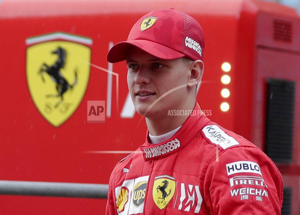 FILE - In this Tuesday, April 2, 2019 file photo, Mick Schumacher walks at the pit during his first F1 test for Ferrari at the Bahrain International Circuit in Sakhir, Bahrain. Mick Schumacher has a long way to go to follow in the footsteps of his father but no one can question he is trying his hardest to emulate the professional work ethic that helped Michael Schumacher become Formula One’s greatest driver. (AP Photo/Hassan Ammar, file)