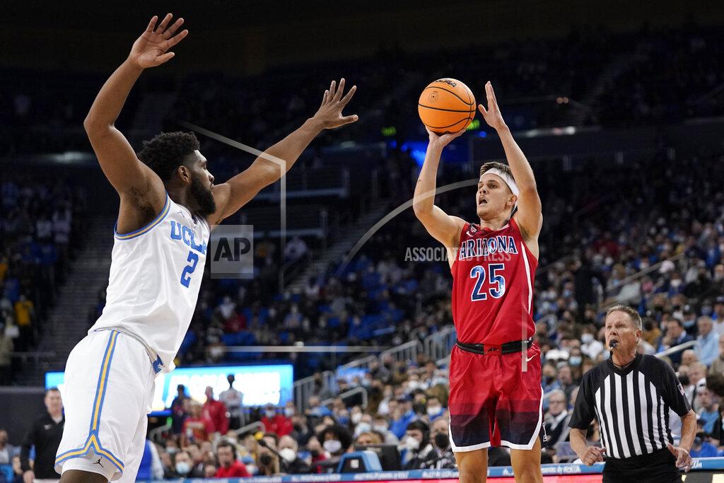 Mark J. Terrill Arizona guard Kerr Kriisa, right, shoots as UCLA forward Cody Riley defends during the first half of an NCAA college basketball game Tuesday, Jan. 25, 2022, in Los Angeles. (AP Photo/Mark J. Terrill)