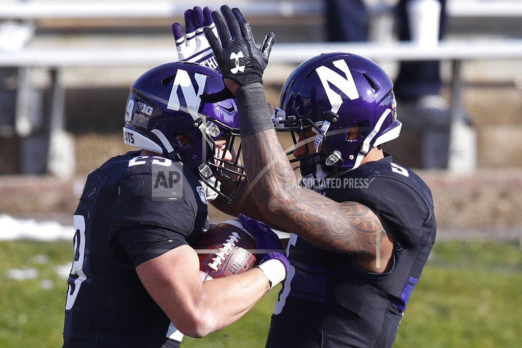 Jim Young Northwestern's Evan Hull, left, celebrates his touchdown against Massachusetts with teammate Jace James during the second half of an NCAA college football game Saturday, Nov. 16, 2019, in Evanston, Ill. (AP Photo/Jim Young)