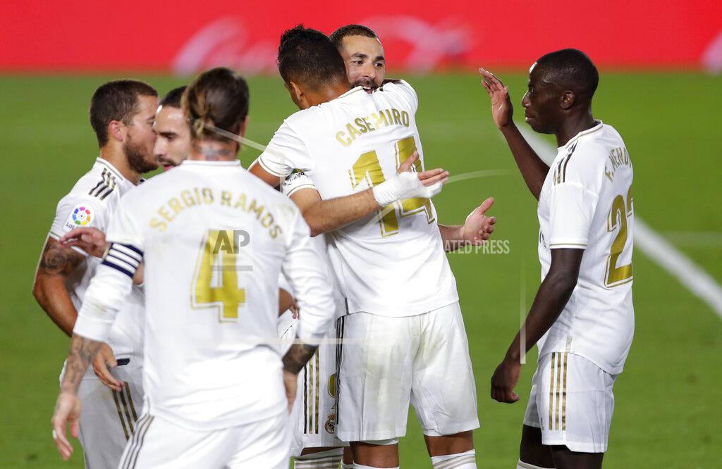 Manu Fernandez Real Madrid's Karim Benzema, second from right, celebrates with his teammates after scoring his side's opening goal during the Spanish La Liga soccer match between Real Madrid and Valencia at Alfredo di Stefano stadium in Madrid, Spain, Thursday, June 18, 2020. (AP Photo/Manu Fernandez)