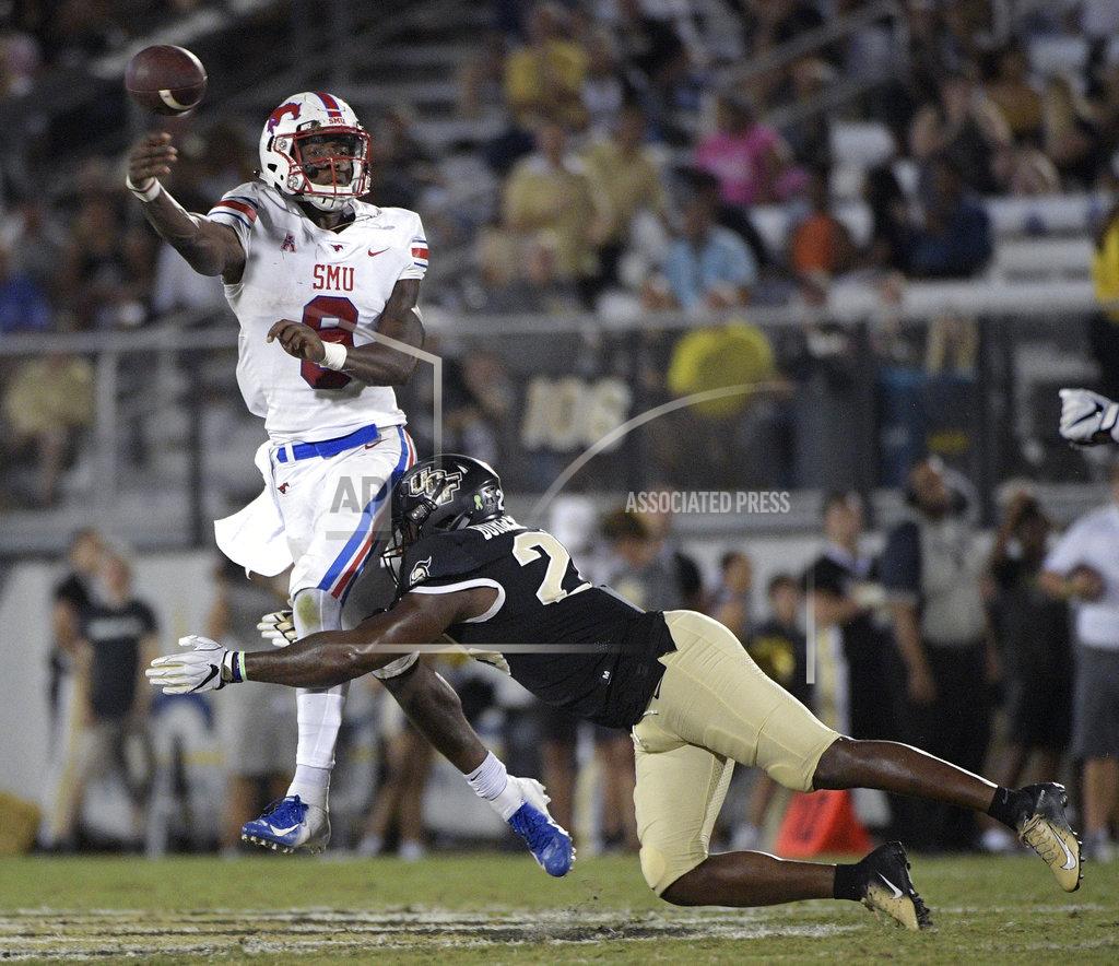 Phelan M. Ebenhack SMU quarterback William Brown (9) throws a pass as he is hit by Central Florida linebacker Shawn Burgess-Becker, right, during the second half of an NCAA college football game Saturday, Oct. 6, 2018, in Orlando, Fla. UCF won 48-20. (AP Photo/Phelan M. Ebenhack)