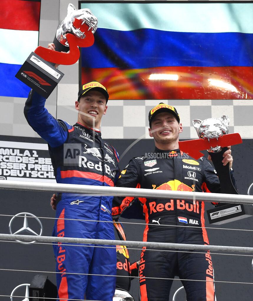 Jens Meyer Red Bull driver Max Verstappen of the Netherland's, right, winner, is flanked by second place Toro Rosso driver Daniil Kvyat of Russia on the podium after the German Formula One Grand Prix at the Hockenheimring racetrack in Hockenheim, Germany, Sunday, July 28, 2019. (AP Photo/Jens Meyer)