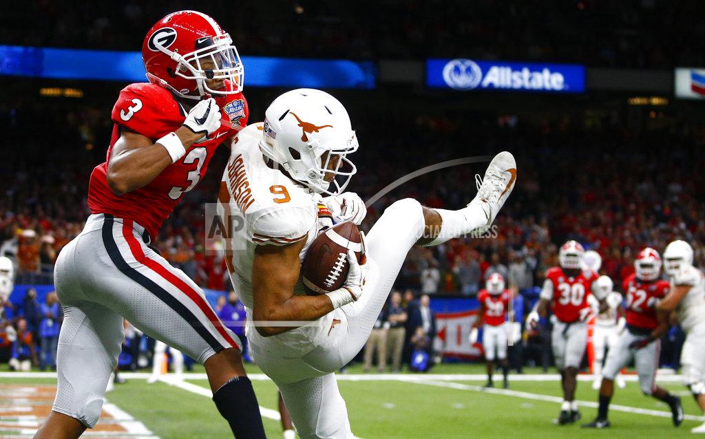 Butch Dill Texas wide receiver Collin Johnson (9) pulls in a 2-point conversion against Georgia defensive back Tyson Campbell (3) during the second half of the Sugar Bowl NCAA college football game in New Orleans, Tuesday, Jan. 1, 2019. (AP Photo/Butch Dill)