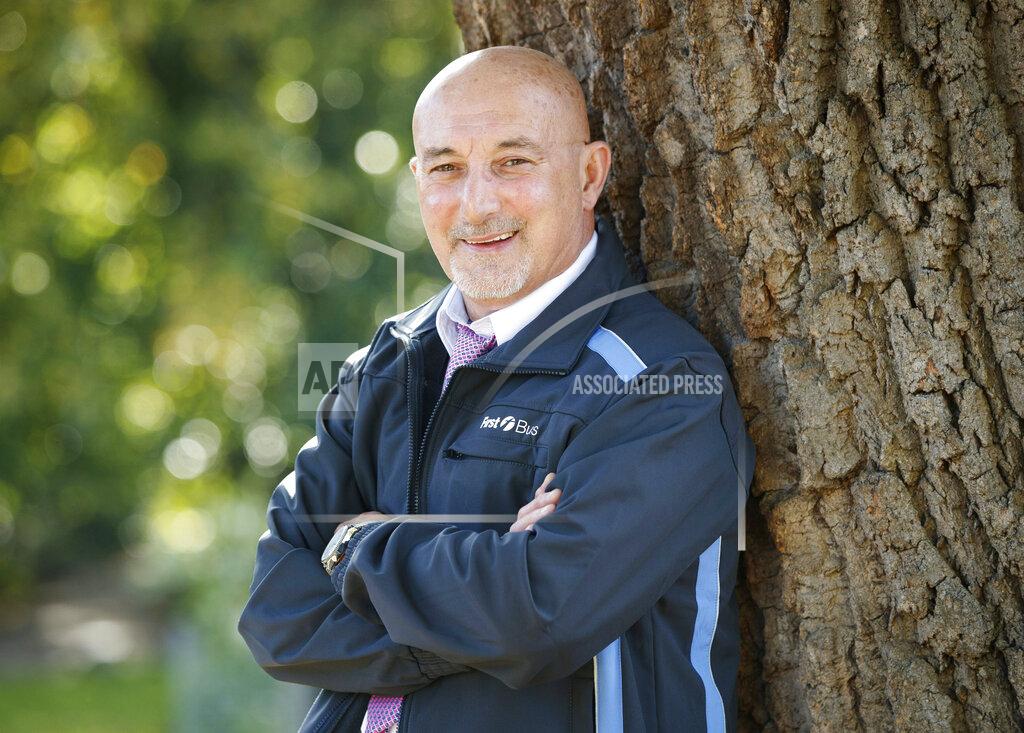 Danny Lawson In this Oct. 7, 2020 photo, Mustafa Kemal Koksal poses for a photo at his home in York, England, Queen Elizabeth II has used her delayed birthday honors list to celebrate the selfless work of people — some more famous than others — in the battle against the coronavirus pandemic. Koksal received a Medal of the Order of the British Empire for services to the community during the pandemic. As an NHS volunteer the 63-year-old completed at least one volunteer duty every day over the two months he couldn't work as a bus supervisor, totalling more than 80 trips to fetch shopping or collect prescriptions for elderly and disabled people in York. (Danny Lawson/PA via AP)