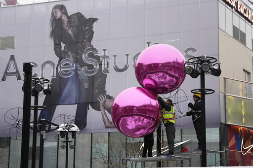 FILE - Workers install decorations ahead of the Christmas festival at a mall in Beijing on Dec. 14, 2023. A survey of factory managers in China shows manufacturing contracted in December in the latest sign the world&rsquo;s No. 2 economy is still sluggish. (AP Photo/Ng Han Guan, File)