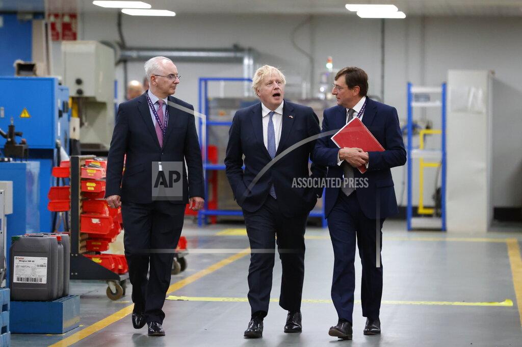 Liam Mcburney Britain's Prime Minister Boris Johnson with Alex Cresswell, CEO of Thales UK, right, and Philip McBride, Managing Director of Thales Belfast, on the factory floor at Thales weapons manufacturer in Belfast, Monday May 16, 2022, during a visit to Northern Ireland. Johnson said there would be “a necessity to act” if the EU doesn't agree to overhaul post-Brexit trade rules that he says are destabilizing Northern Ireland's delicate political balance. Johnson held private talks with the leaders of Northern Ireland's main political parties, urging them to get back to work. (Liam McBurney/Pool via AP)