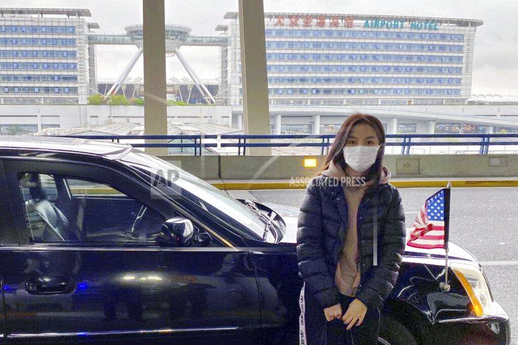 Uncredited This photo provided by Daniel Hsu shows his wife, Jodie Chen, standing next to the car of the U.S. consul-general in Shanghai, before her flight home to her daughter in Seattle, after being blocked from leaving China for nearly three years. The U.S. diplomat escorted her to the departure gate. (Daniel Hsu via AP)