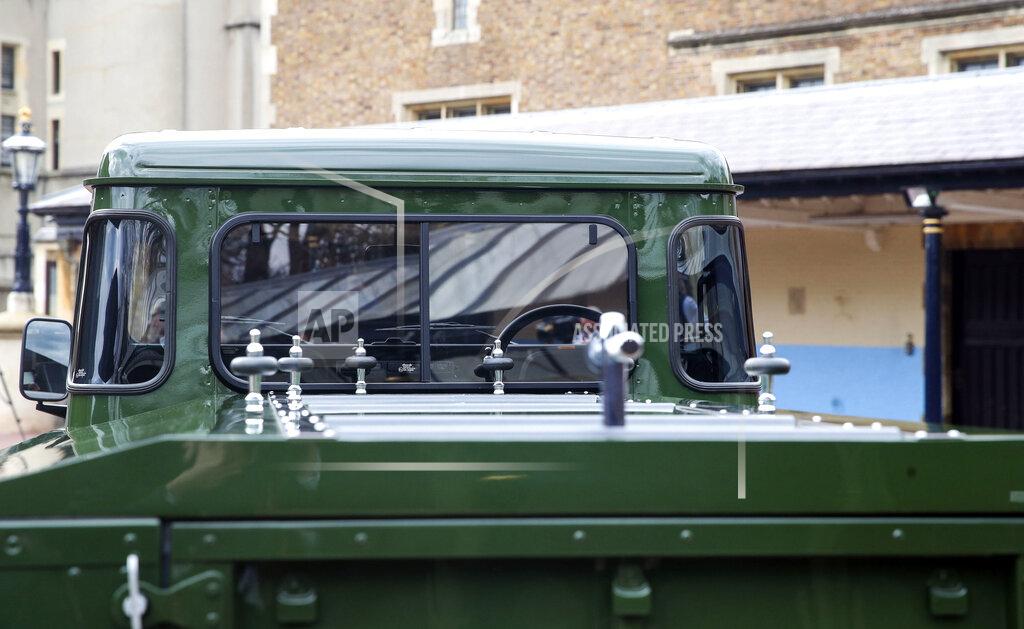 Steve Parsons The Jaguar Land Rover that will be used to transport the coffin of the Duke of Edinburgh at his funeral on Saturday, is pictured at Windsor Castle, in Berkshire, England, Wednesday, April 14, 2021. The modified Land Rover Defender TD5 130 chassis cab vehicle was made at Land Rover's factory in Solihull in 2003 and Philip oversaw the modifications throughout the intervening years, requesting a repaint in military green and designing the open top rear and special "stops" to secure his coffin in place. (Steve Parsons/Pool Photo via AP)
