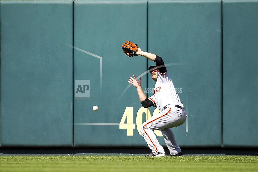 Scott Kane San Francisco Giants center fielder Austin Slater (13) is unable to catch a fly ball hit by St. Louis Cardinals' Paul Goldschmidt during the seventh inning of a baseball game Saturday, May 14, 2022, in St. Louis. (AP Photo/Scott Kane)