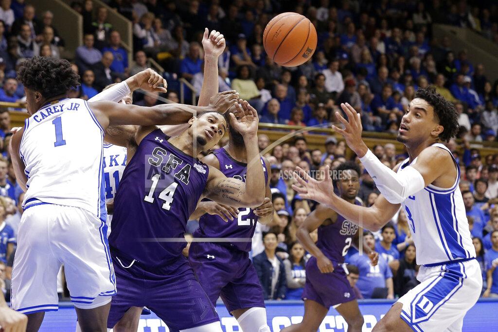 Gerry Broome Duke center Vernon Carey Jr. (1) and guard Tre Jones, right, guard Stephen F. Austin forward Gavin Kensmil (14) during the first half of an NCAA college basketball game in Durham, N.C., Tuesday, Nov. 26, 2019. (AP Photo/Gerry Broome)