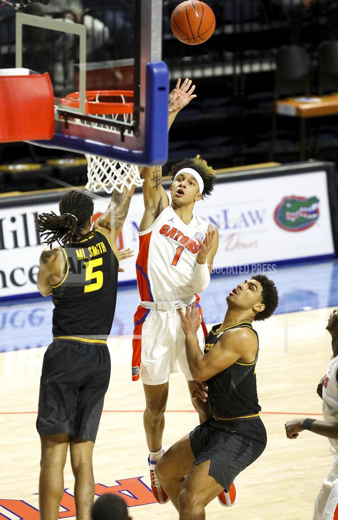 Brad Mcclenny Florida guard Tre Mann (1) scores on a floater he puts up over the Missouri defense during an NCAA college basketball game, Wednesday, March 3, 2021 in Gainesville, Fla. (Brad McClenny/The Gainesville Sun via AP)
