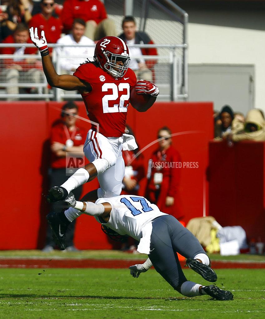 Butch Dill Alabama running back Najee Harris (22) hurdles Citadel defensive back Chris Beverly (17) as he carries the ball during the first half of an NCAA college football game, Saturday, Nov. 17, 2018, in Tuscaloosa, Ala. (AP Photo/Butch Dill)