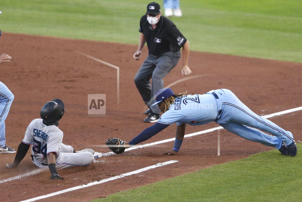 Jeffrey T. Barnes Miami Marlins' Magneuris Sierra is safe on first as Toronto Blue Jays' Vladimir Guerrero Jr. attempts to make the tag during the third inning of a baseball game, Wednesday, Aug. 12, 2020, in Buffalo, N.Y. (AP Photo/Jeffrey T. Barnes)