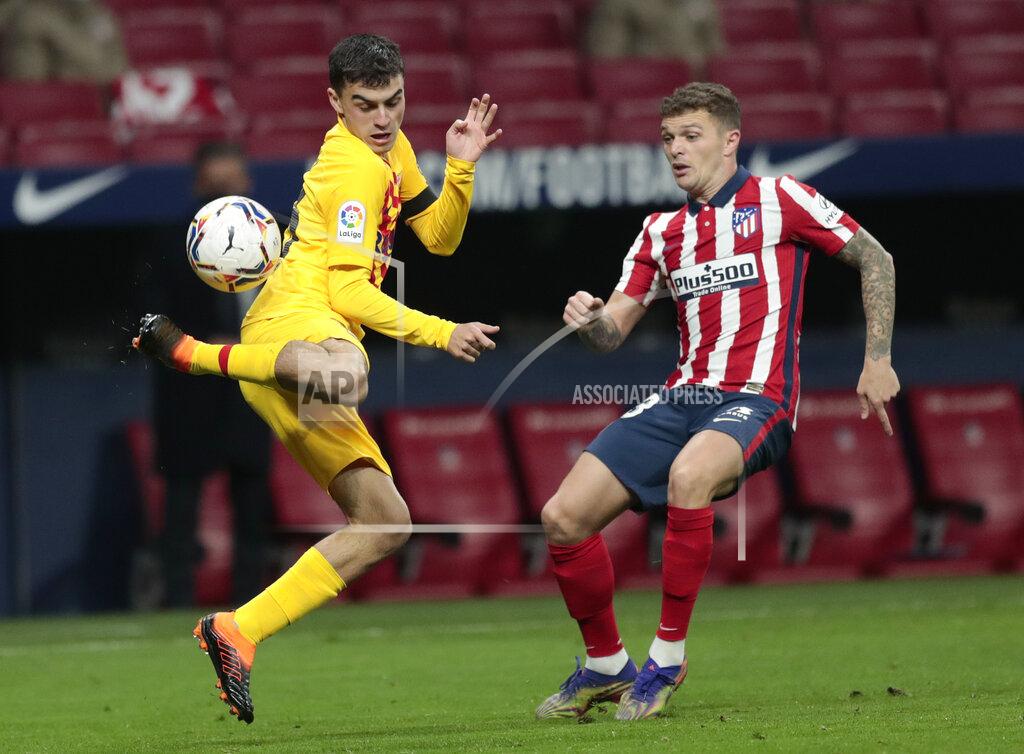 Bernat Armangue Barcelona's Pedri, left, flicks the balls as hr is challenged by Atletico Madrid's Kieran Trippier during the Spanish La Liga soccer match between Atletico Madrid and FC Barcelona at the Wanda Metropolitano stadium in Madrid, Spain, Saturday, Nov. 21, 2020. (AP Photo/Bernat Armangue)