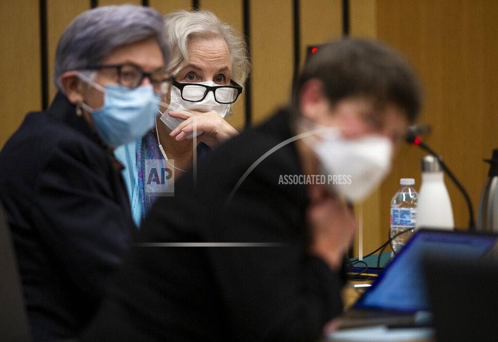 Dave Killen FILE - Romance writer Nancy Crampton Brophy, background, accused of killing her husband, Dan Brophy, in June 2018, is surrounded by her defense attorneys in court in Portland, Ore., Monday, April 4, 2022. A jury in Portland, Oregon, has convicted the self-published romance novelist — who once wrote an essay titled "How to Kill Your Husband" — of fatally shooting her husband four years ago. (Dave Killen/The Oregonian via AP, Pool, File Photo)