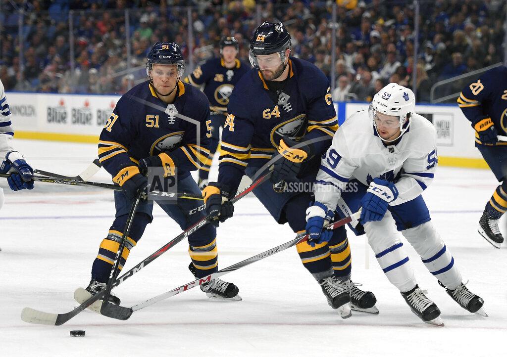 Adrian Kraus FILE - Buffalo Sabres center Kyle Criscuolo (51), right wing Tyler Randell (64) and Toronto Maple Leafs right wing Jeremy Bracco (59) battle for the puck during the second period of an NHL preseason hockey game in Buffalo, N.Y., in this Saturday, Sept. 22, 2018, file photo. Former minor league hockey player Ty Randell turned down a contract offer to pursue a career in firefighting. Randell went to firefighting school as part of the Professional Hockey Players Association’s career enhancement program. (AP Photo/Adrian Kraus, File)