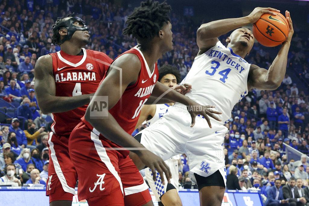 James Crisp Kentucky's Oscar Tshiebwe (34) pulls down a rebound near Alabama's Juwan Gary (4) and Jahvon Quinerly (13) during the first half of an NCAA college basketball game in Lexington, Ky., Saturday, Feb. 19, 2022. (AP Photo/James Crisp)