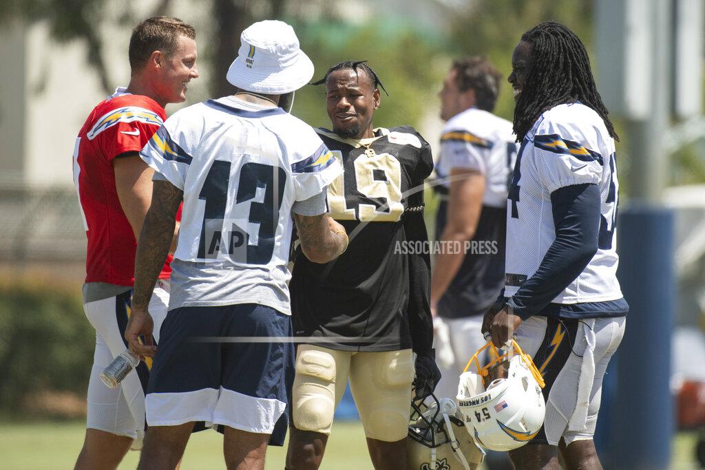 Kyusung Gong Los Angeles Chargers quarterback Philip Rivers, left, wide receiver Keenan Allen, and defensive end Melvin Ingram, right, chat with New Orleans Saints wide receiver Ted Ginn during a joint NFL practice in Costa Mesa, Calif., Thursday, Aug. 15, 2019. (AP Photo/Kyusung Gong)