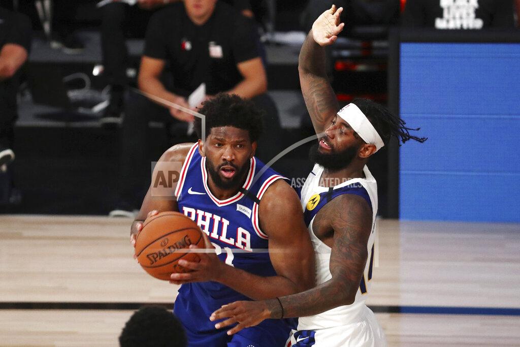 Kim Klement Philadelphia 76ers center Joel Embiid (21) drives to the basket against Indiana Pacers forward JaKarr Sampson during the third quarter of an NBA basketball game Saturday, Aug. 1, 2020, in Lake Buena Vista, Fla. (Kim Klement/Pool Photo via AP)