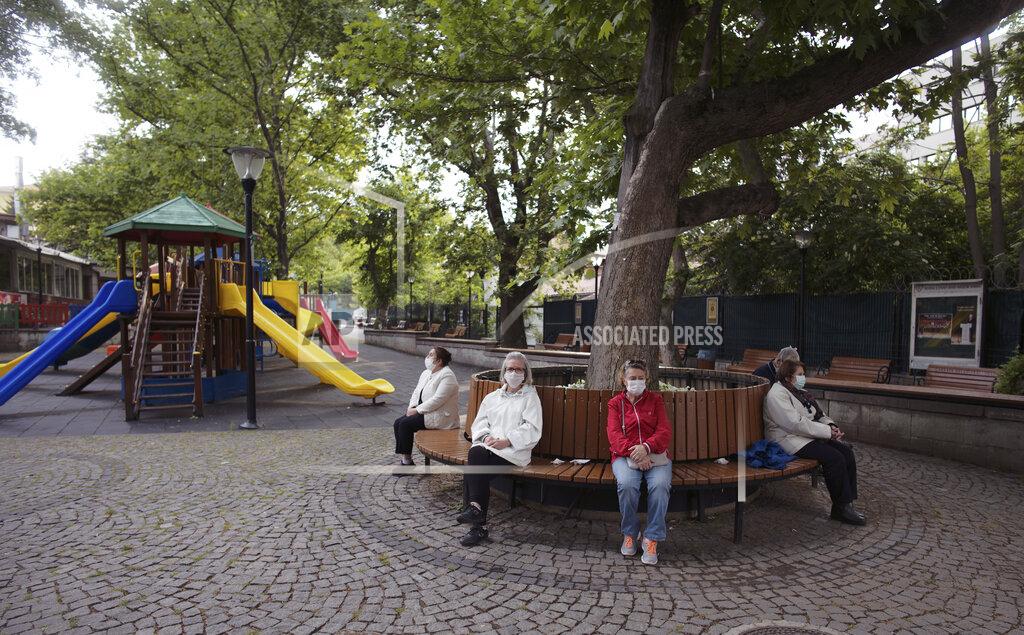 Burhan Ozbilici People sit in a public garden as only senior Turks over 65 have been allowed to go out for six hours during a curfew declared by the government in an attempt to control the spread of coronavirus, in Ankara, Turkey, Sunday, May 31, 2020. The country has opted to impose short weekend and holiday curfews, instead of full lockdowns, fearing possible negative effects on the already troubled economy.(AP Photo/Burhan Ozbilici)