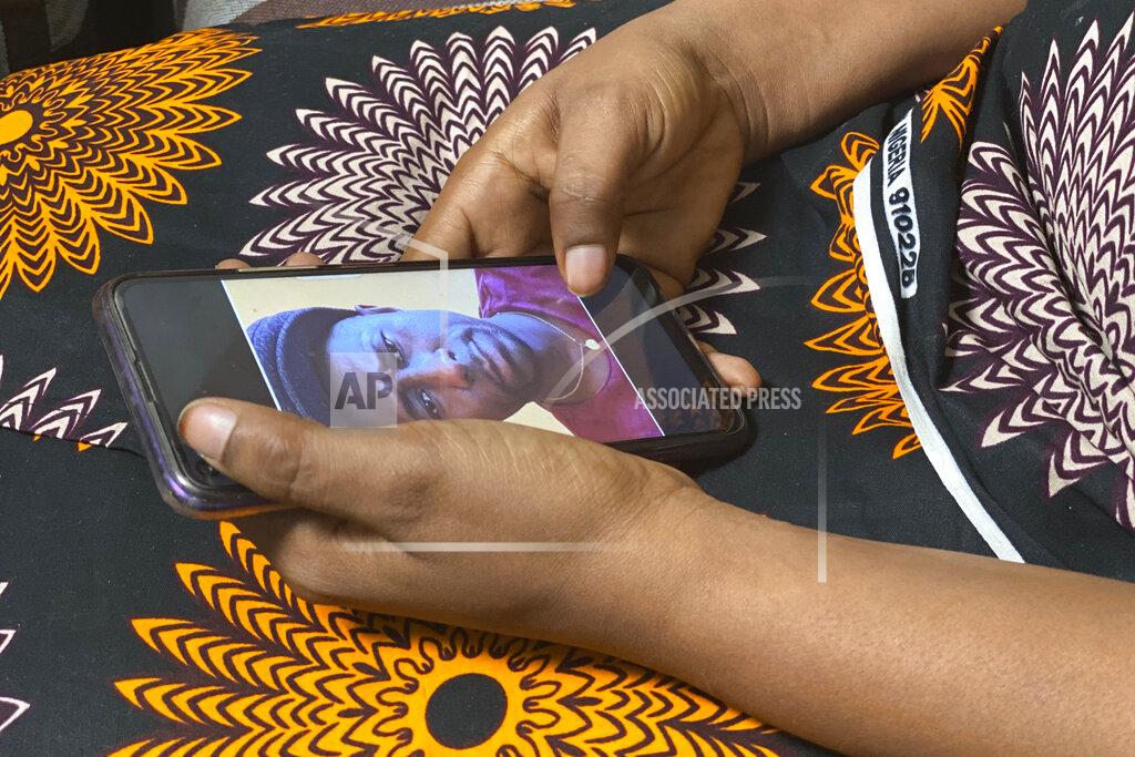 Kudra Maliro Anifa holds her phone displaying a photo of former World Health Organization doctor Boubacar Diallo, of Canada, during an interview in the eastern Congo town of Goma on Friday, March 5, 2021. In 2019, Diallo met her when she was working in an Ebola treatment center in Beni, eastern Congo. She said Diallo told her: “How can a beautiful girl like you work here, testing people’s temperatures and washing their hands? That’s terrible.” She said he offered her another job at five times more than her current salary where “the conditions were very simple,” according to him. She rejected Diallo’s offer, saying that “if he hires me after sleeping with him...I would be a sex slave, not a WHO employee.” Diallo rejected those claims outright. (AP Photo/Kudra Maliro)