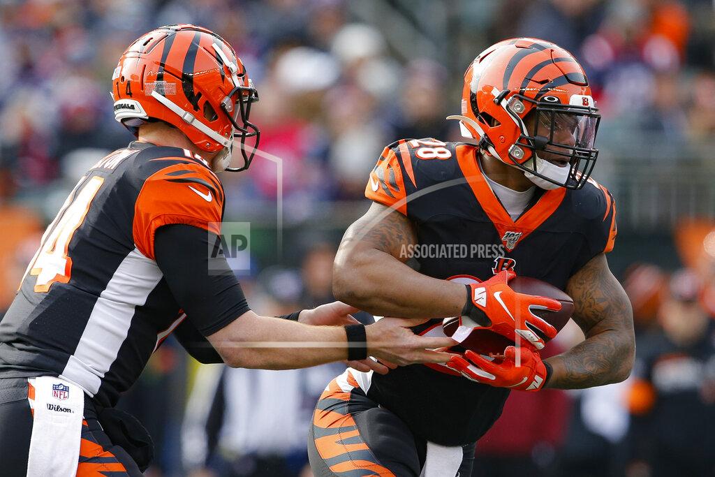 Gary Landers Cincinnati Bengals quarterback Andy Dalton, left, hands off the ball to running back Joe Mixon (28) in the first half of an NFL football game against the New England Patriots, Sunday, Dec. 15, 2019, in Cincinnati. (AP Photo/Gary Landers)