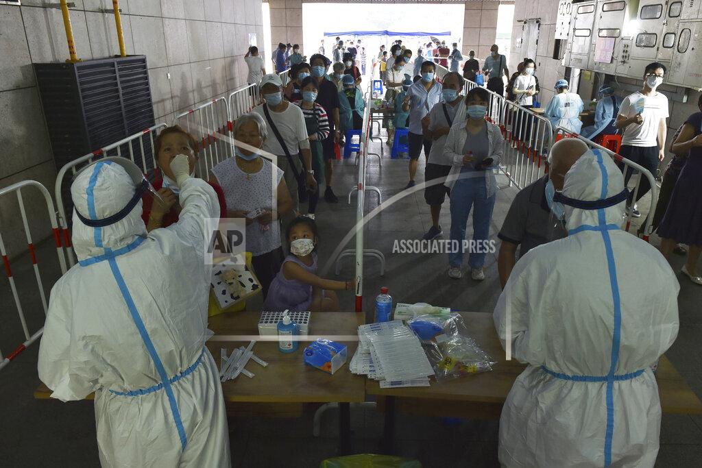 Uncredited Medical workers takes throat swab samples in new round of COVID-19 testing in Nanjing city in eastern China's Jiangsu province Monday, Aug. 2, 2021 The current coronavirus outbreaks in China, while still in the hundreds of cases in total, have spread much more widely than previous ones, reaching multiple provinces and cities including the capital, Beijing. Many of the cases have been identified as the highly contagious delta variant that is driving a resurgence in many countries. (Chinatopix via AP)