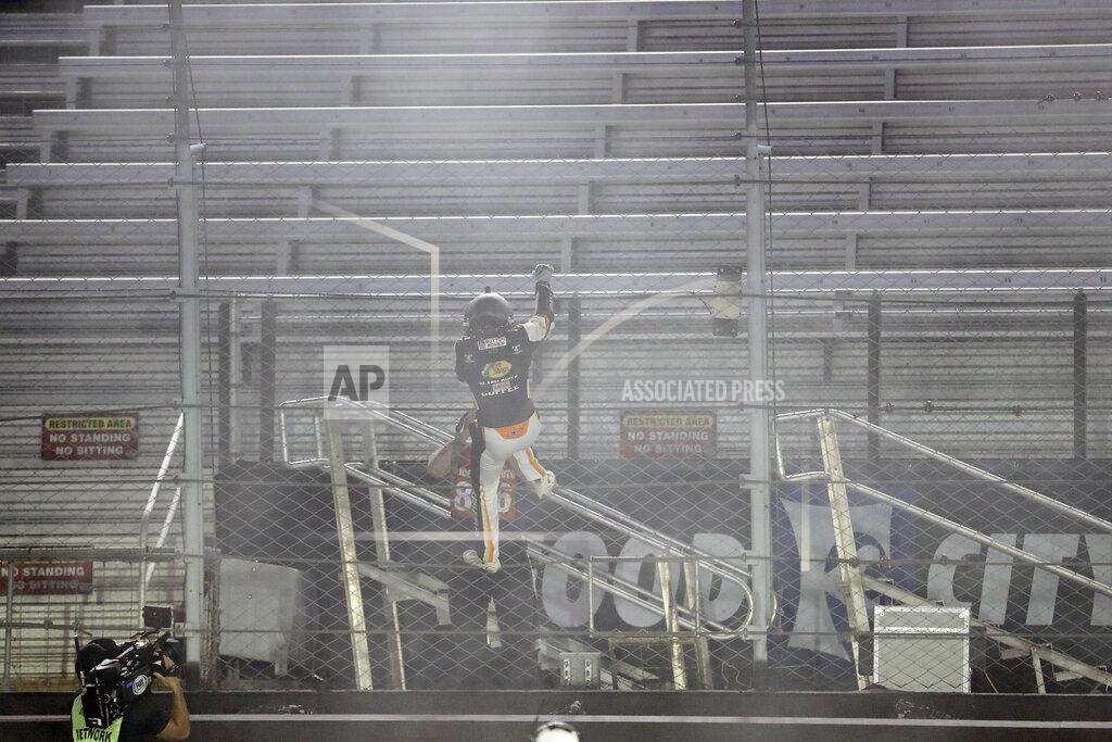 Mark Humphrey Noah Gragson (9) celebrates by climbing the fence in front of empty stands after winning a NASCAR Xfinity Series auto race at Bristol Motor Speedway Monday, June 1, 2020, in Bristol, Tenn. (AP Photo/Mark Humphrey)