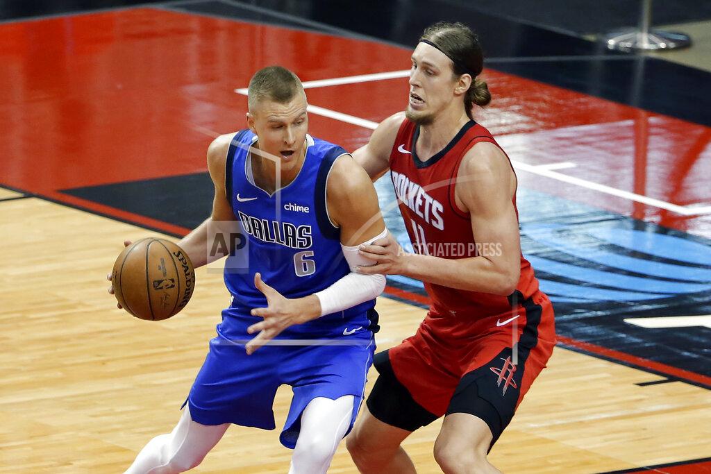 Michael Wyke Dallas Mavericks center Kristaps Porzingis (6) looks to drive around Houston Rockets forward Kelly Olynyk (41) during the second half of an NBA basketball game Wednesday, April 7, 2021, in Houston. (AP Photo/Michael Wyke, Pool)