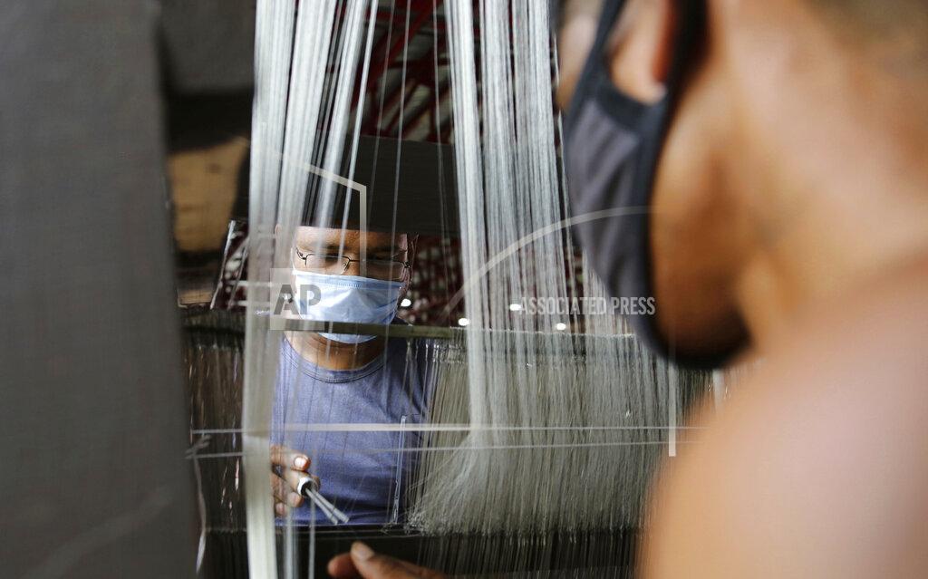 Channi Anand People wear face masks and work at a silk factory on the outskirts of Jammu, India, Friday, Aug. 14, 2020. Sericulture is a major economic activity in hundreds of villages in the Jammu and Kashmir region. (AP Photo/ Channi Aanad)