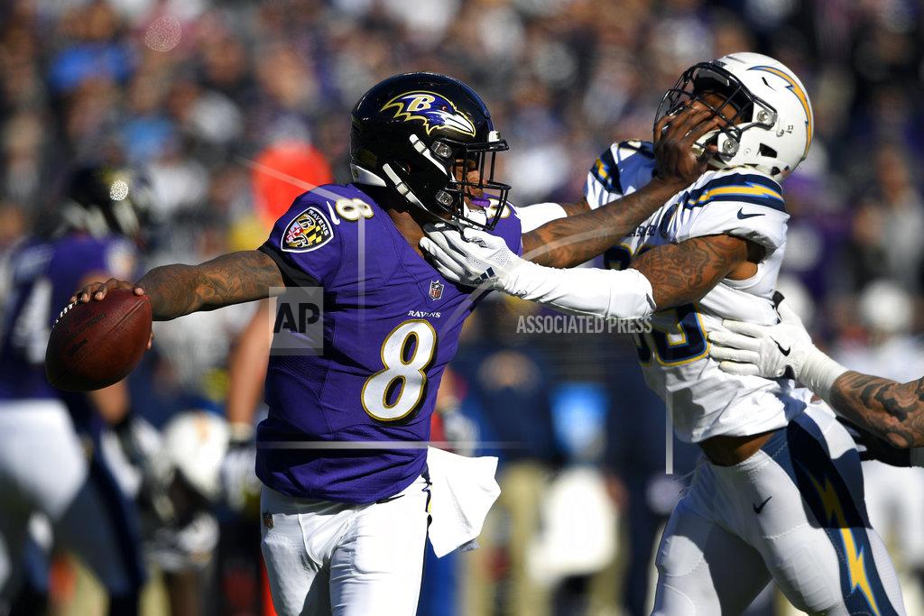 Nick Wass Baltimore Ravens quarterback Lamar Jackson (8) tries to break free from Los Angeles Chargers free safety Derwin James in the first half of an NFL wild card playoff football game, Sunday, Jan. 6, 2019, in Baltimore. (AP Photo/Nick Wass)