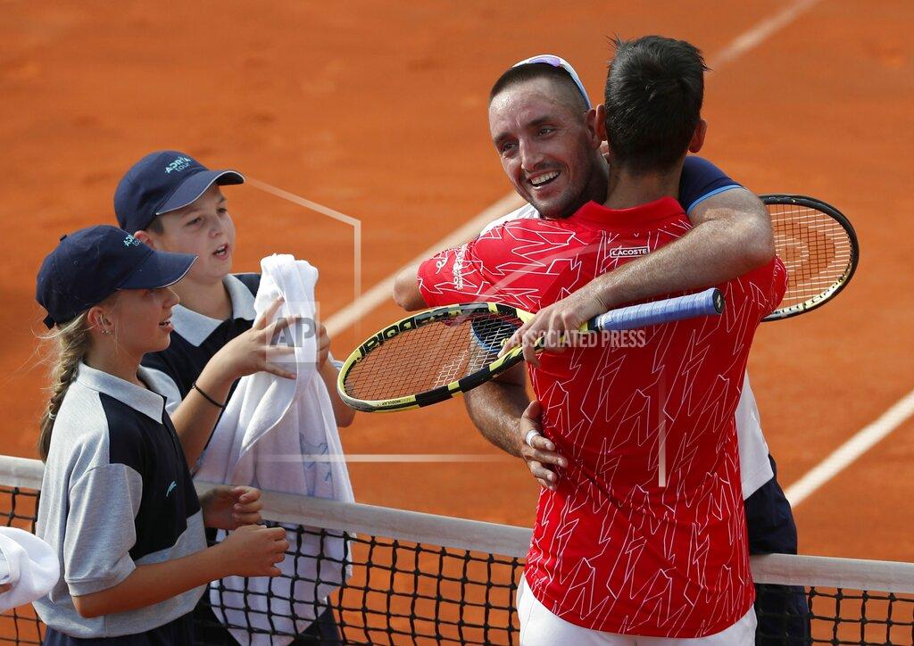Darko Vojinovic In this Saturday, June 13, 2020 photo, Serbia's Novak Djokovic, front right, hugs with Serbia's Viktor Troicki after their match of the Adria Tour charity tournament in Belgrade, Serbia. Novak Djokovic has tested positive for the coronavirus after taking part in a tennis exhibition series he organized in Serbia and Croatia. The top-ranked Serb is the fourth player to test positive for the virus after first playing in Belgrade and then again last weekend in Zadar, Croatia. Viktor Troicki said Tuesday that he and his pregnant wife have both been diagnosed with the virus. (AP Photo/Darko Vojinovic)
