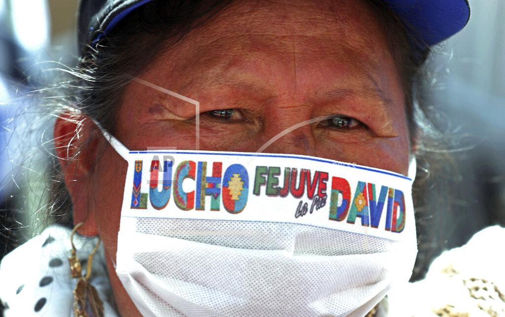 Martin Mejia A supporter of presidential candidate Luis Arce wears a mask amid the COVID-19 pandemic outside his headquarters one day after elections in La Paz, Bolivia, Monday, Oct. 19, 2020. Evo Morales' party, with Arce as its candidate, claimed victory in a presidential election that appeared to reject the right-wing policies of the interim government that took power in Bolivia after the leftist leader resigned and fled the country a year ago. (AP Photo/Martin Mejia)