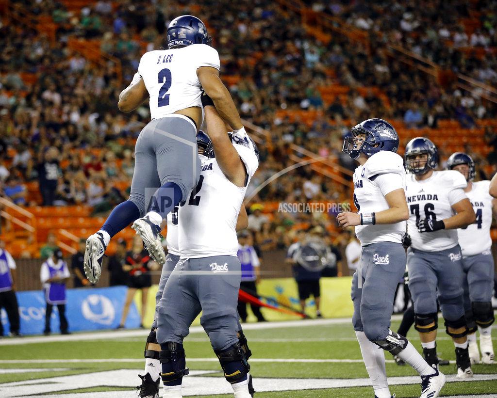 Marco Garcia Nevada running back Devonte Lee (2) gets lifted in the air by offensive lineman Anthony Palomares (62) after Lee scored a touchdown against Hawaii during the second quarter of an NCAA college football game, Saturday, Oct. 20, 2018, in Honolulu. (AP Photo/Marco Garcia)