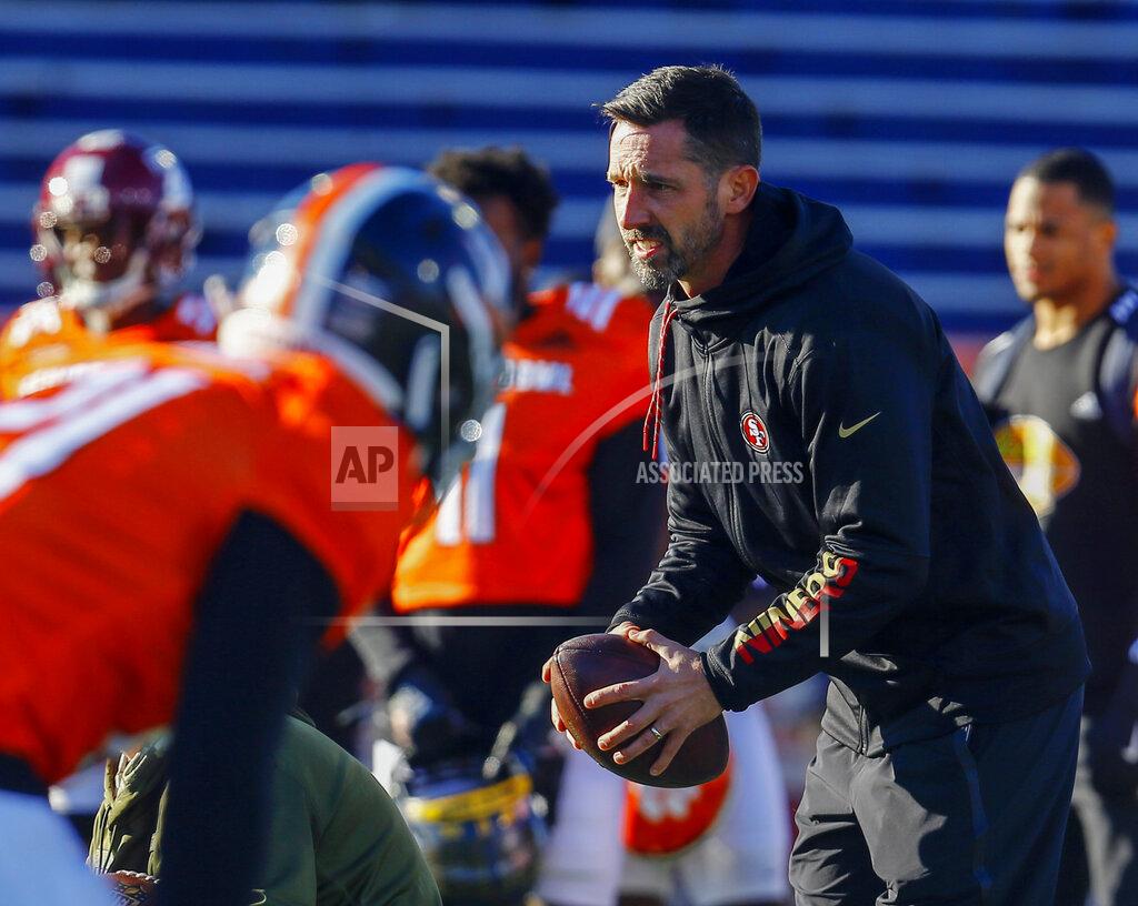 Butch Dill FILE - In this Thursday, Jan. 24, 2019, file photo, South head coach Kyle Shanahan of the San Francisco 49ers takes a snap during practice for the Senior Bowl college football game, in Mobile, Ala. Shanahan knows his 49ers NFL football team can go in one of two directions with the No. 2 overall pick in the draft. Take the top available pass rusher to help upgrade a defense that struggled to create takeaways a year earlier or move down in the draft and accumulate additional draft picks. (AP Photo/Butch Dill, File)