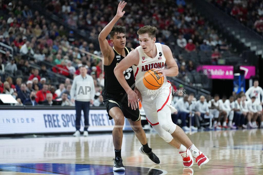 John Locher Arizona's Azuolas Tubelis (10) drives around Colorado's Tristan da Silva (23) during the first half of an NCAA college basketball game in the semifinal round of the Pac-12 tournament Friday, March 11, 2022, in Las Vegas. (AP Photo/John Locher)